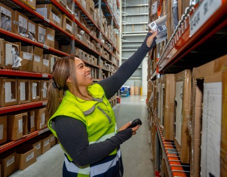Person reaching in modern 3PL warehouse