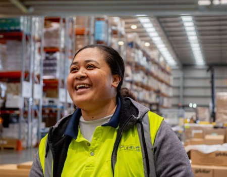 3PL operator smiling in modern warehouse